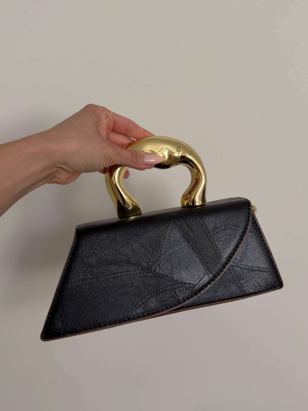 Elegant Black Top-Handle Leather Bag with Gold Sculpted Handle